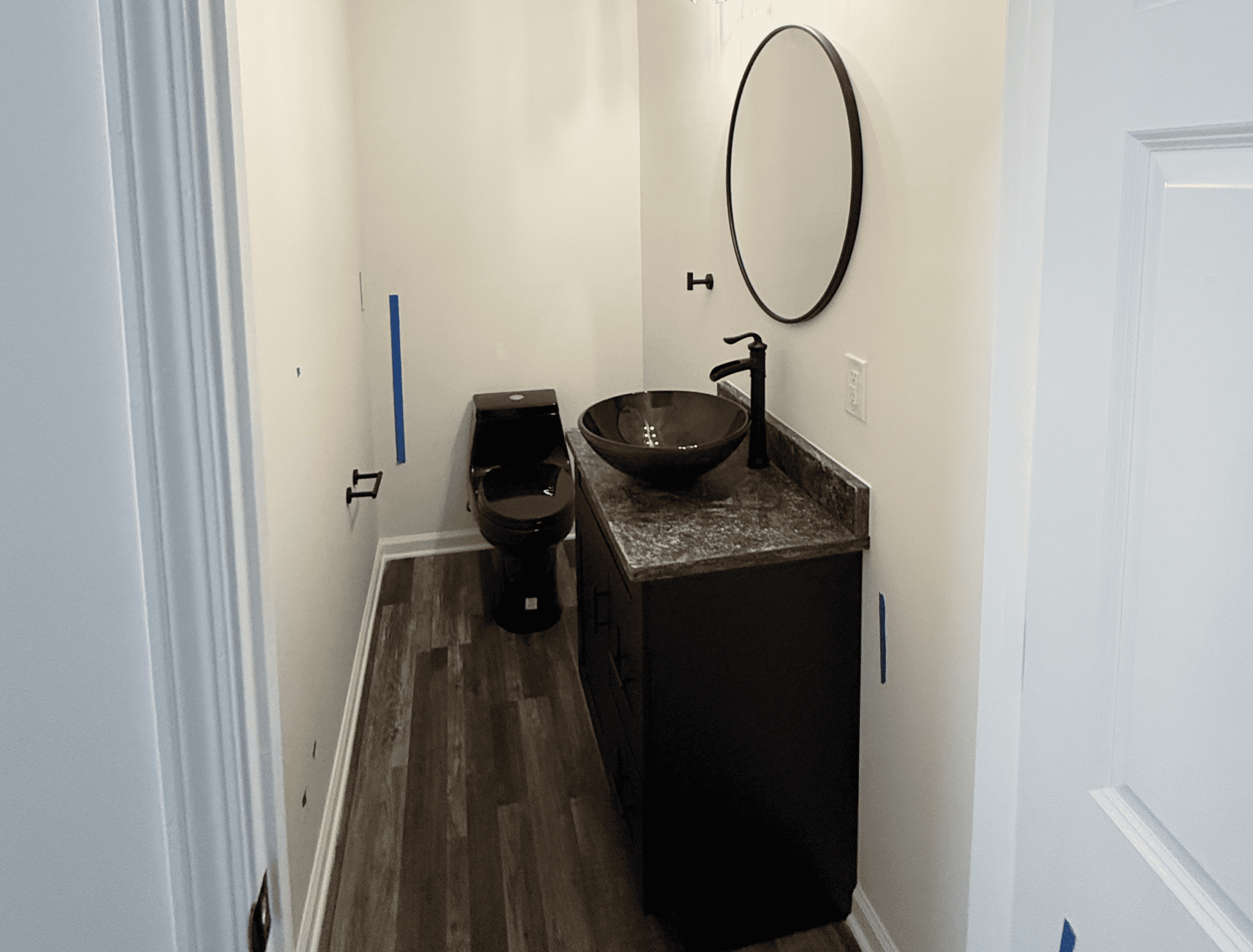 Modern bathroom with black fixtures and a vessel sink.