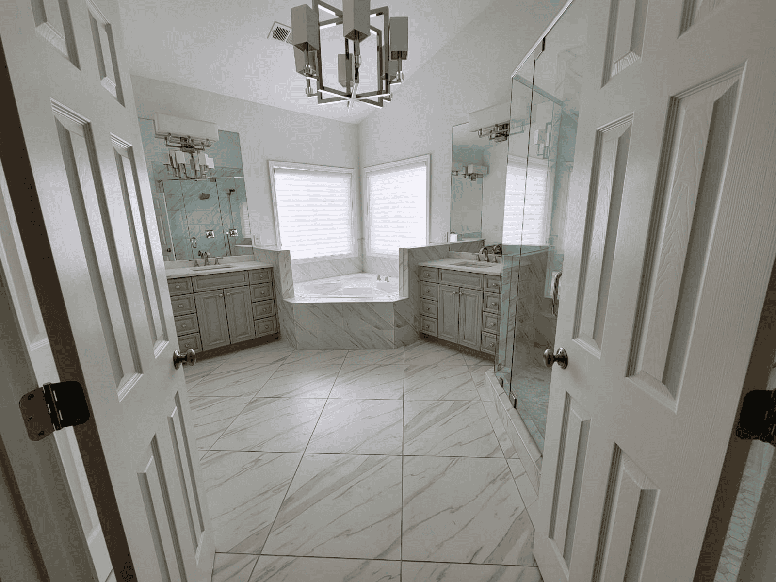 Modern Bathroom with Double Vanities Bathroom with double vanities, marble countertops, and a glass-enclosed shower in a bright, spacious.