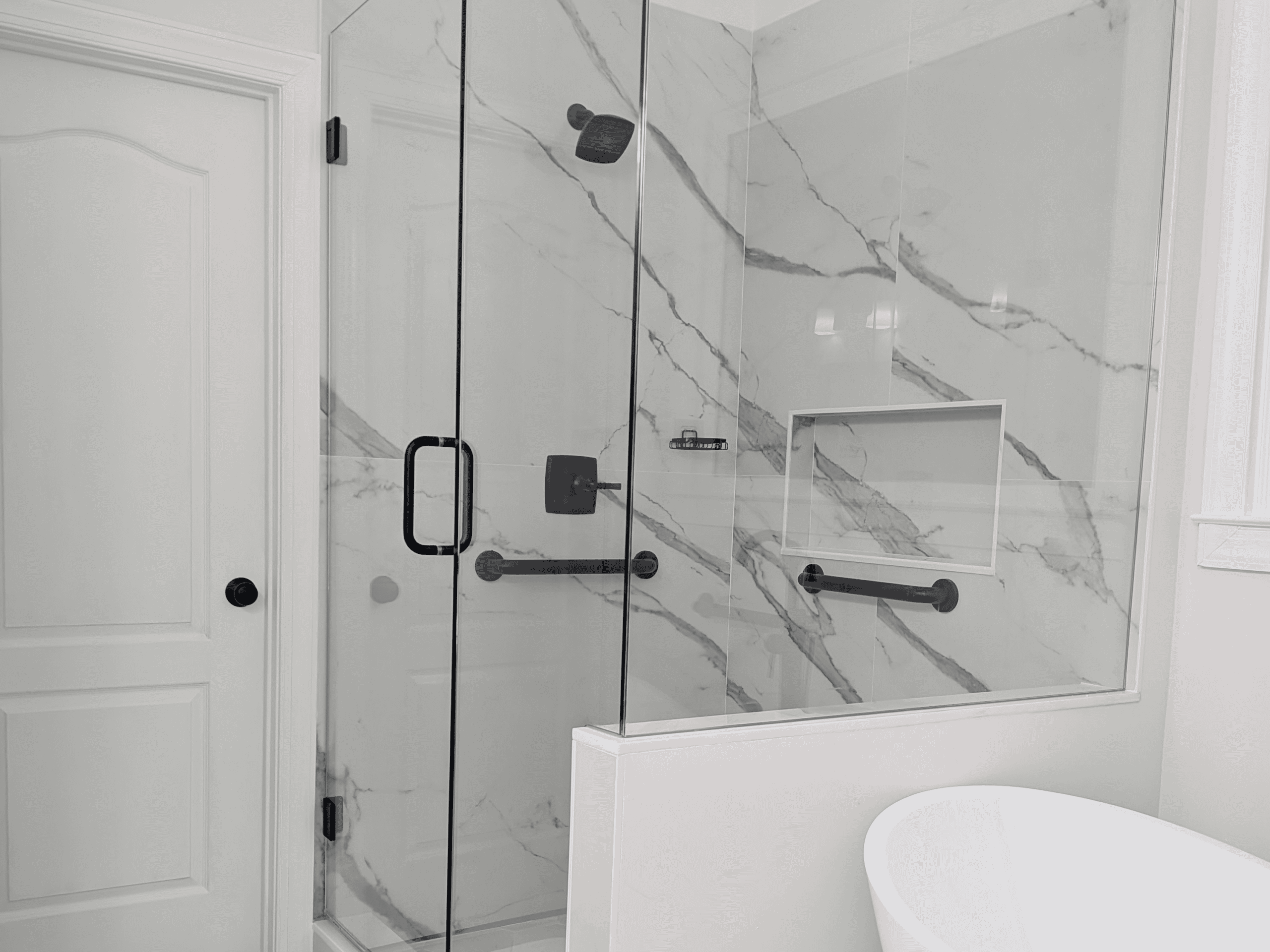 Modern Marble Shower Elegant marble shower with black fixtures and glass enclosure in a contemporary bathroom.