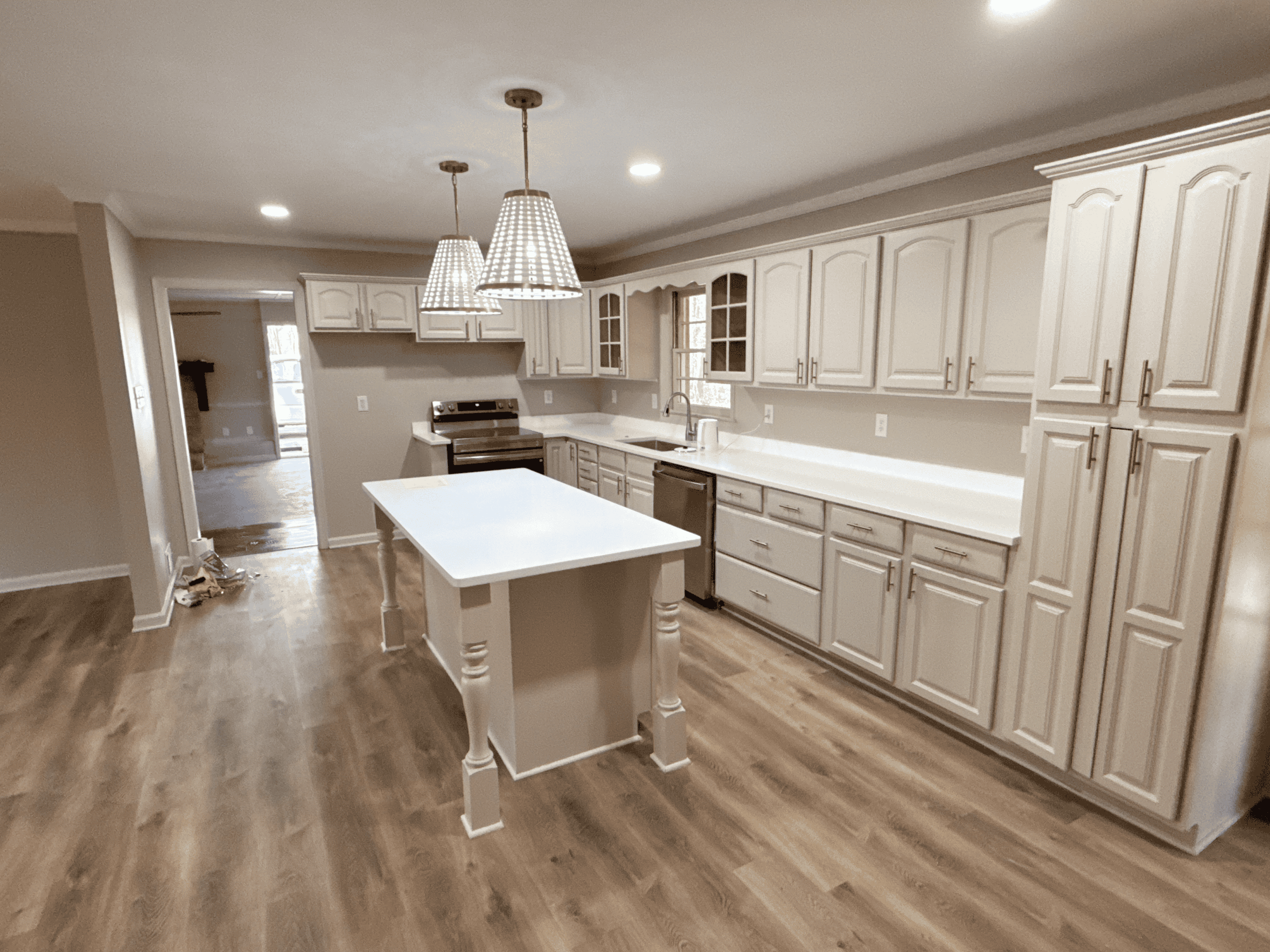 Modern White Kitchen with Island Bright and spacious kitchen featuring white cabinetry and a central island for cooking and dining. P.