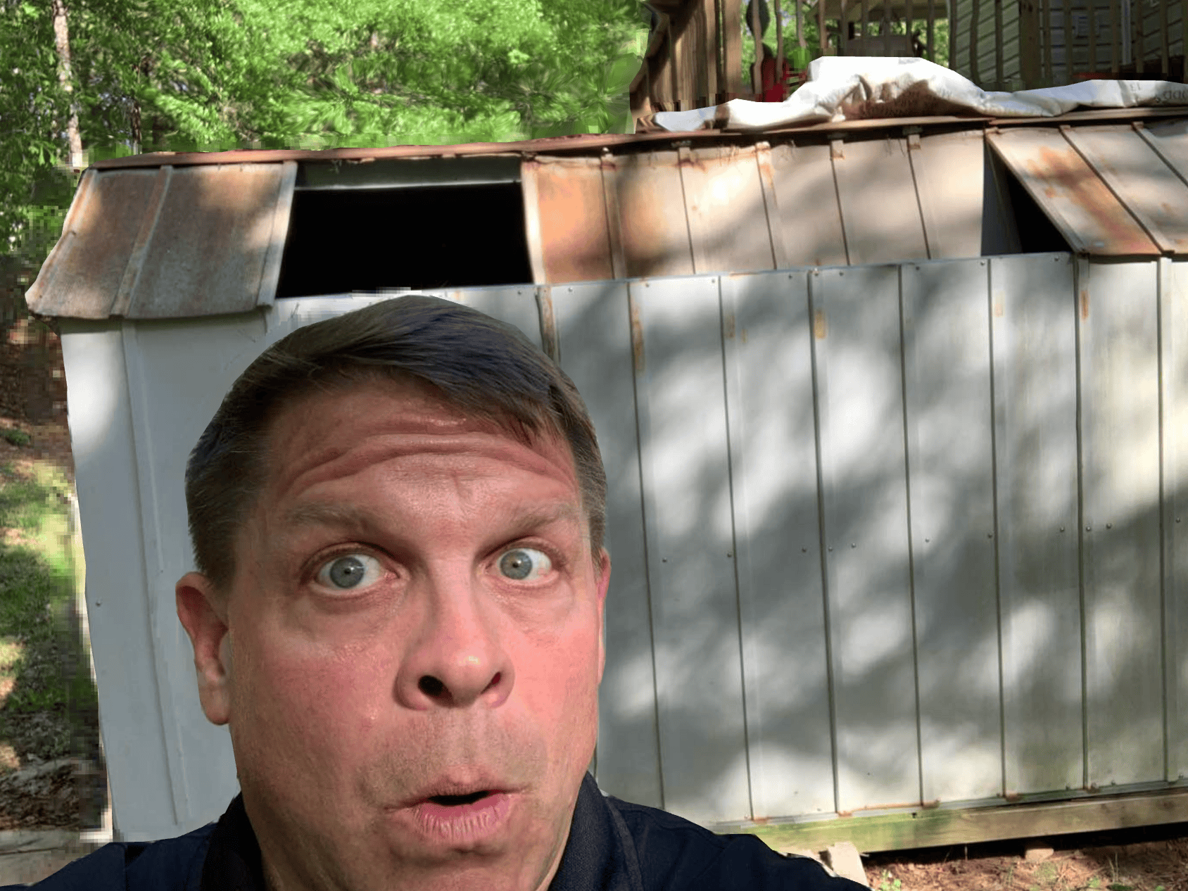 Backyard shed with rusted roof and weathered siding, showing signs of aging and needing repair.