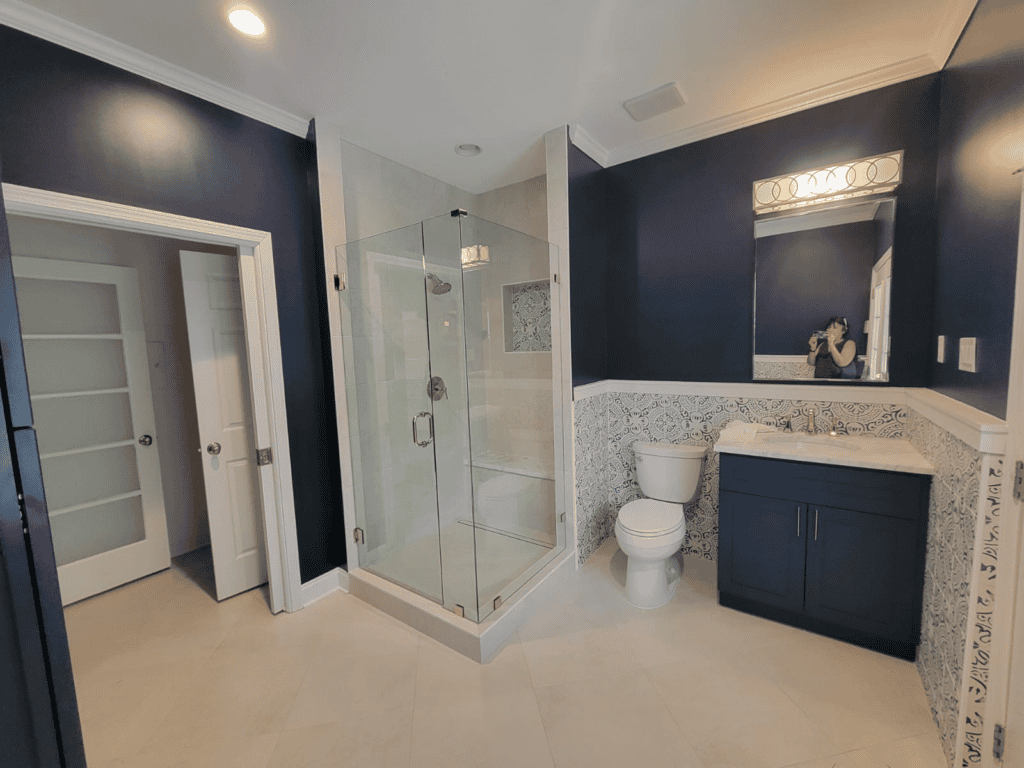 Bathroom with glass shower enclosure and modern vanity.