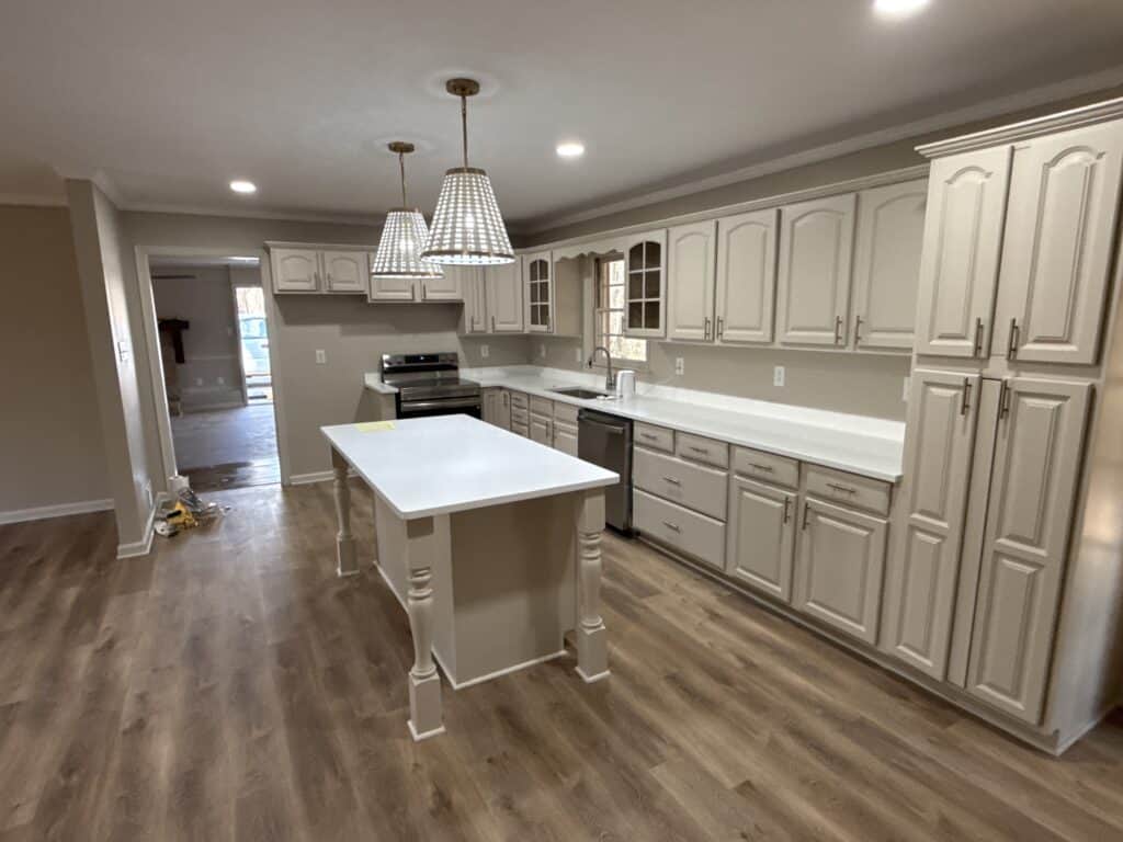 Modern kitchen with white cabinetry and island for cooking and entertaining.