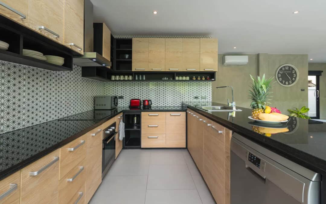 Contemporary kitchen with wooden cabinets, black countertops, and modern appliances.