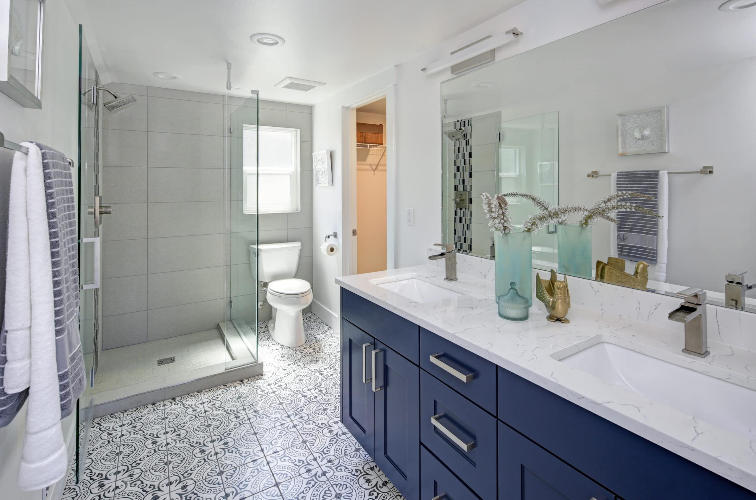 Contemporary bathroom with walk-in shower, double vanity, and stylish decor.